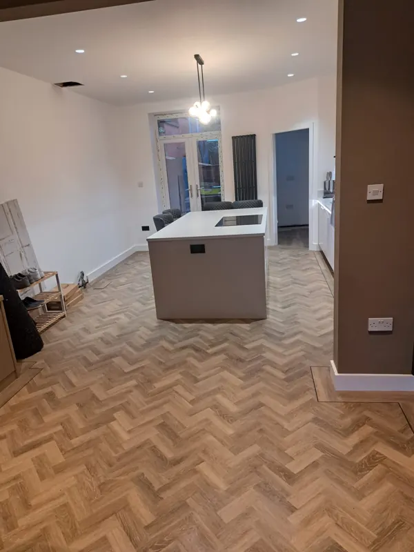 Amtico herringbone LVT through an open-plan kitchen
